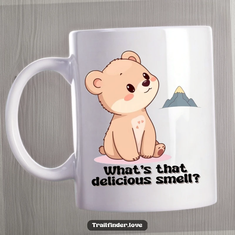 Funny Bear Cub Mug showing a curious cub tilting its head towards a distant, tiny mountain, evoking wonder and a sense of adventure.
