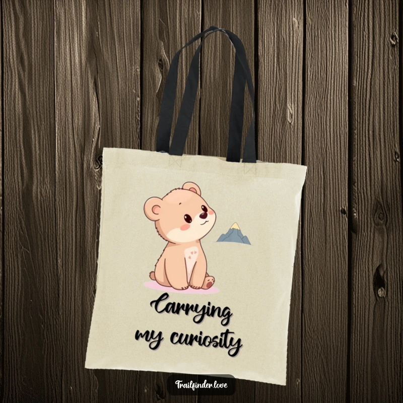 Funny Bear Cub Tote Bag illustrating a curious cub tilting its head towards a distant, tiny mountain, perfect for carrying dreams and essentials.